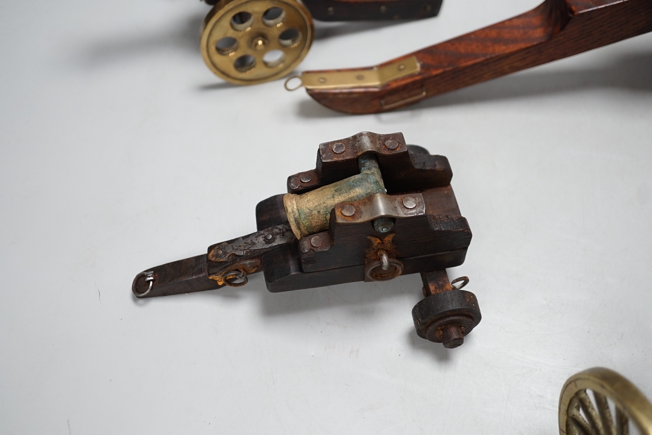 A bronze 'Napoleon bust' desk seal, 8.5cm tall, together with four models of cannons. Largest 39cm wide